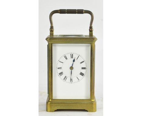 An early 20th century brass cased carriage clock with white enamel dial, visible escapement and a French single train movemen