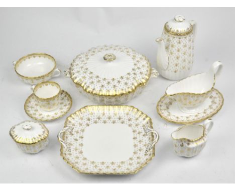 A Spode dinner and tea service decorated in the 'Fleur De Lys Gold' pattern (Y8063-B), comprising ; three lidded tureens (29.