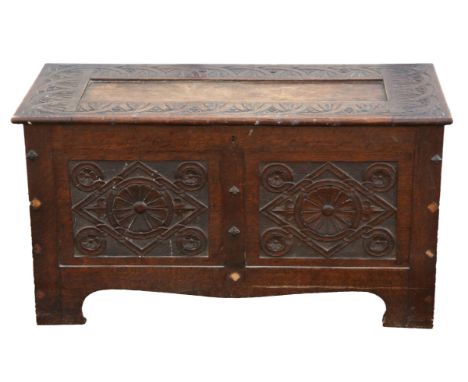 A small Victorian oak coffer, in the Charles II style, the hinged lid above a lozenge carved twin panel front, H 52cm, W 95cm