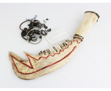 An Elk jaw bone war axe with bone handle and red painted decoration, 41cm long, together with a quantity on metal items inclu