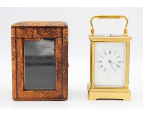 A French carriage clock, with architectural case, the white enamel dial with Roman and Arabic numeral chapter ring, the movem