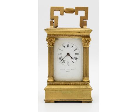 An early 20th century miniature brass cased carriage clock.  The white enamelled dial detailed 'LONDON AND RYDER PARIS', flan