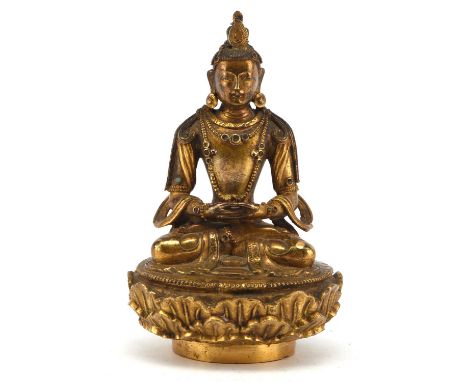 A gilded metal figure of a Buddhist Deity, possibly Amitayus [Amitabha], a Principal Deity of Pure Land Buddhism. Seated in d