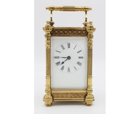 A 20th century brass cased carriage clock.  The white enamelled dial flanked by pillar supports, the bevelled glass panels en