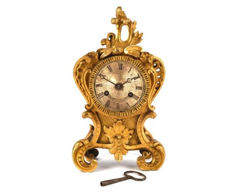 A 19th century French ormolu Rococo mantle clock, the engine turned silvered dial with Roman numerals, signed  Fraye a Paris.