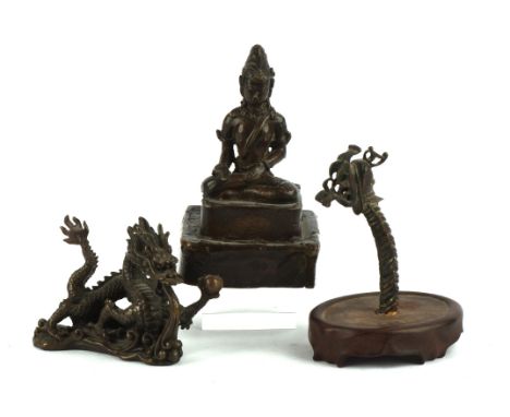 Three small metal alloy sculptures, comprising: a Buddhist Deity [possibly Avalokitesvara] seated in dhyanasana on a square, 