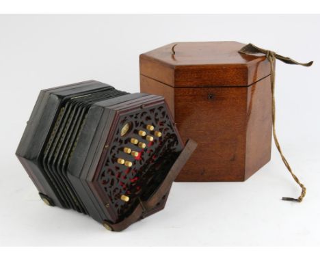 An early 20th century, Lachenal and Co concertina with leather bellows, pierced fretwork hexagonal ends and twenty one bone b