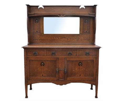 Manner of Shapland and Petter, an Arts and Crafts oak sideboard, with tall back board with long book shelf, above mirrored pa
