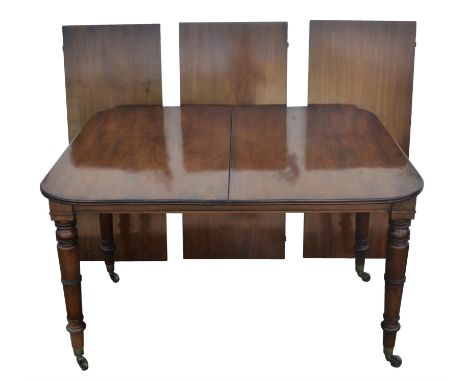 A George IV mahogany extending dining table, 1820s, the pull-out mechanism with three leaf insertions, on ring turned tapered