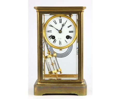 A brass four glass mantel clock, early 20th Century, the case of plain design, the white enamel dial with Roman numeral chapt