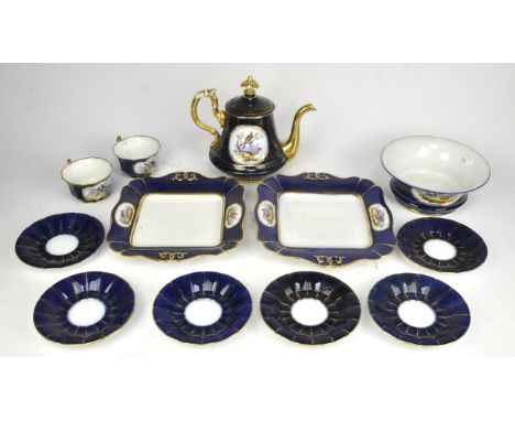A French Sevres style porcelain part tea service, late 19th/early 20th Century, decorated with reserves of birds, on blue gro