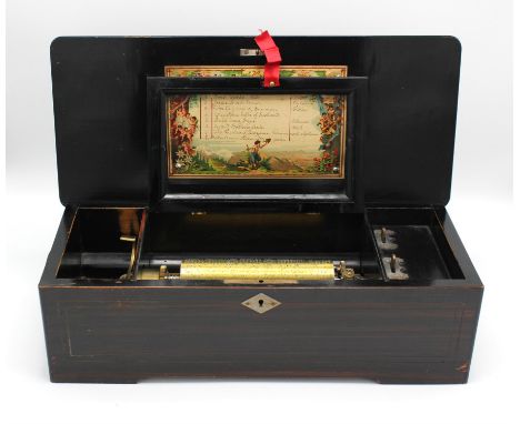 A late 19th century, walnut cased Swiss music box playing eight airs.  The marquetry inlaid hinged lid opening to reveal a si
