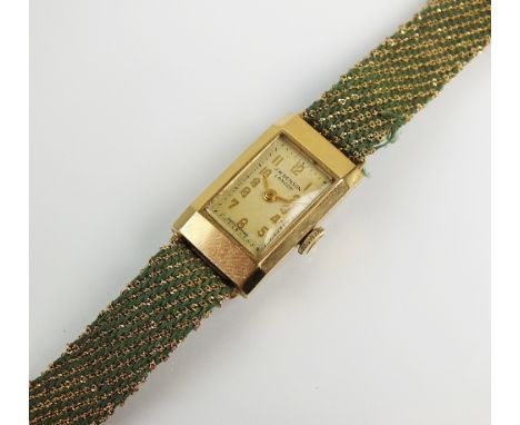 A Lady's 9ct gold J.W. Benson Art Deco wristwatch, the rectangular silvered dial with gold Arabic numerals, manual wind, with