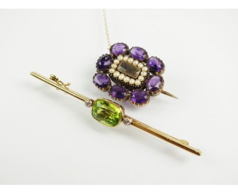 A peridot and diamond bar brooch, designed as a central mixed cushion cut peridot flanked to each side by an old cut diamond,