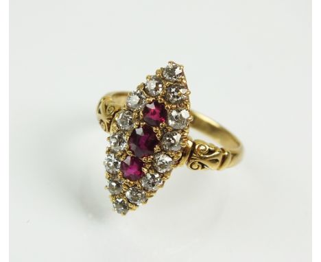 A Victorian 18ct gold ruby and diamond navette cluster ring, designed as three graduated oval mixed cut rubies claw set withi