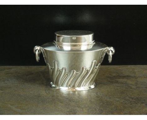 A silver tea caddy, William Hutton & Sons Ltd, Birmingham 1913, of oval form with embossed wrythen decoration and two loop ha