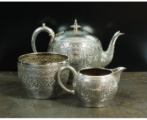 A Victorian Scottish three piece silver tea service, JR, Glasgow 1886, each piece of circular form in the Indian manner with 