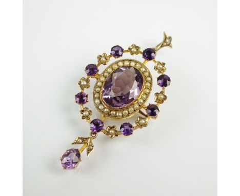 An early 20th century amethyst and split seed pearl pendant/brooch, designed as a central oval mixed cut amethyst, collet set