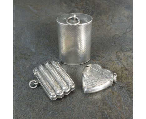 An engine turned oval silver vesta case, Henry William Dee, London 1869, together with a silver heart shaped vesta case, Birm