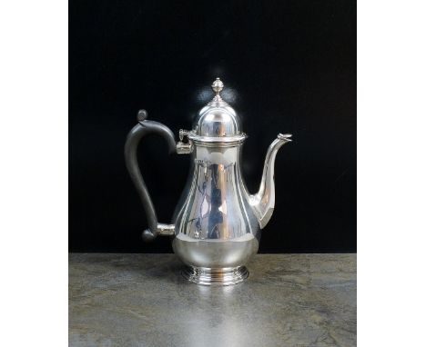 A George II style silver coffee pot, Barker Ellis Silver Co, Birmingham 1966, of plain polished baluster form with urn finial