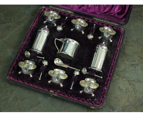 A cased Victorian nine piece silver cruet set, Horace Woodward & Co, London 1890, comprised of two plain polished cylindrical