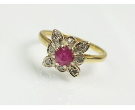 An 18ct yellow gold ruby and diamond cluster ring, the central round mixed cut ruby claw set within a stylised square diamond