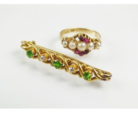 A demantoid garnet and diamond bar brooch, designed as a row of three round mixed cut garnets interspersed with two old cut d