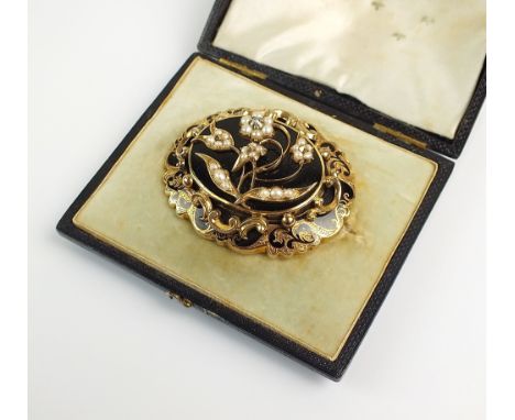 A Victorian diamond, pearl and enamel mourning brooch, designed a central seed pearl and diamond floral motif mounted to blac