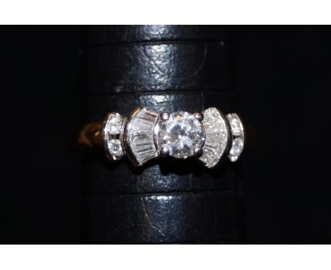 18 ct Gold &amp; diamond ring central solitaire with baguette diamonds on the shoulders approximately 0.5ct Size J