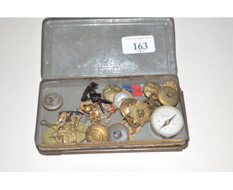 A George V gift tin containing various buttons, badges, compass etc.
