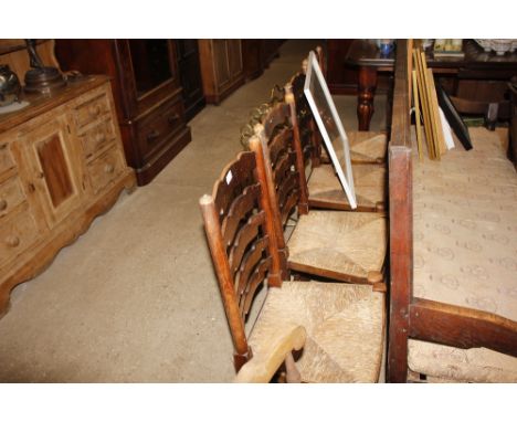A set of four ladder back and rush seated dining chairs 