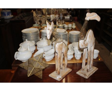 A model of a camel; another of a giraffe; and a ceiling light shade