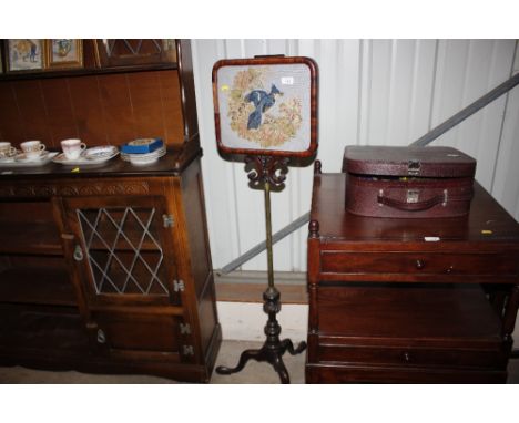 A Victorian mahogany pole screen embroidered panel decorated with a bird on tripod base