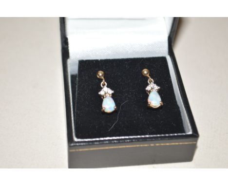 A pair of opal and diamond drop earrings