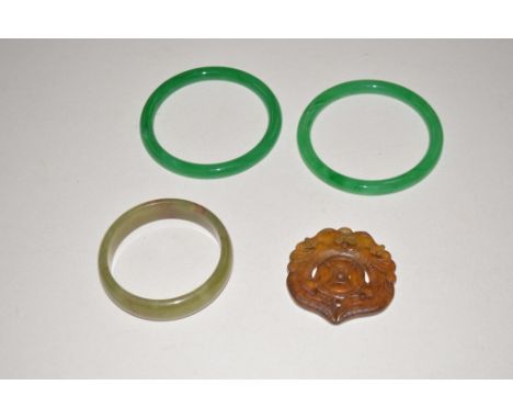 Three jade bracelets and a pendant