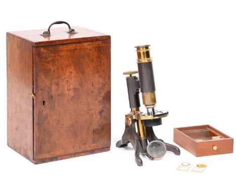 A brass compound microscope, E Bryan Manchester, circa 1900, with eyepiece, objective lens, plano/concave mirror, mahogany ca