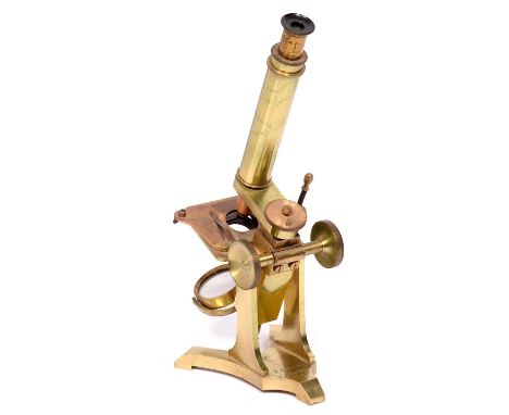 A brass compound student's microscope, M Pillischer London No. 400, with eyepiece, objective lens, plano/concave mirror, on Y