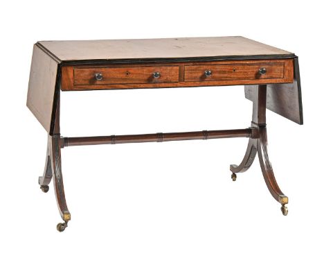 A George III mahogany and ebony line inlaid sofa table, with reeded edge and rectangular drop-leaves, on reeded uprights and 