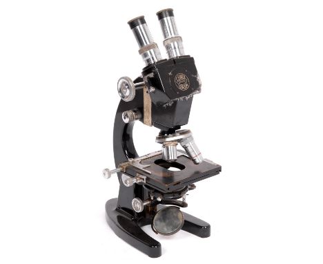 A compound binocular microscope C Baker London, No. 20402, second quarter 20th Century,&nbsp;with two eyepieces, three object