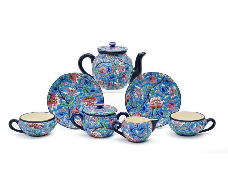 A Longwy tea service, early 20th c, with brightly coloured 'cloisonne' flowers and foliage on a vivid turquoise ground, teapo