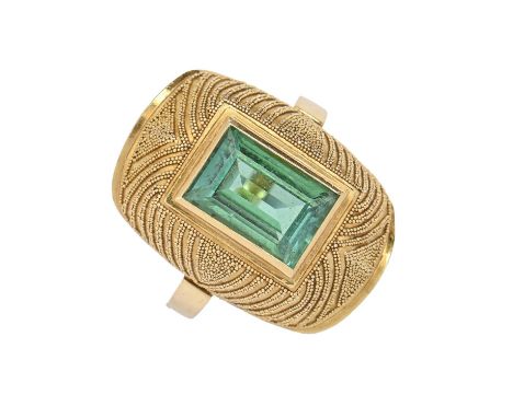 A tourmaline ring, the rectangular step cut green tourmaline in domed and beaded setting, in gold, signed G, 5.1g, size M  Go