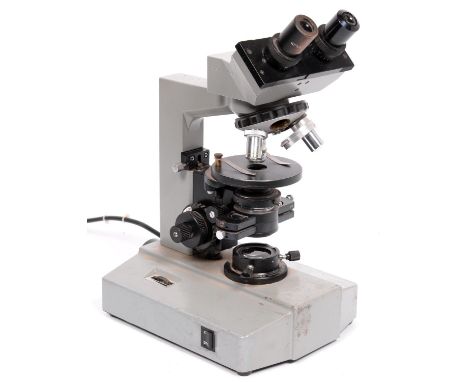 A compound binocular microscope Kyowa Tokyo No. 846260, with two eyepieces, quadruple nose piece with three objective lenses,