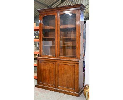 A Victorian mahogany bookcase, c. 1860,&nbsp;moulded outswept cornice above a pair of&nbsp;glazed doors enclosing three adjus