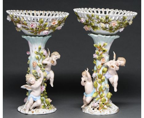 A pair of Plaue floral encrusted fruit stands and detachable baskets, late 19th c, of open trellis design, the rustic stand w