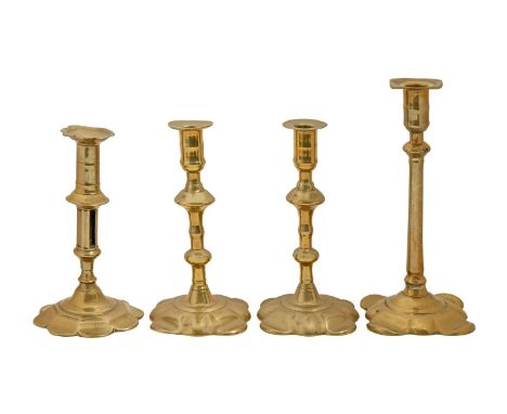 Two and a pair of English brass candlesticks, mid 18th c, with petal base, 18.5 - 23.5cm h, the tallest example stamped Geo G