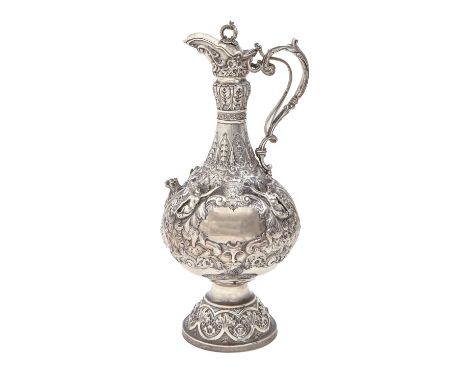 A Victorian silver claret jug,&nbsp;of baluster shape with lever action to the lid, the body richly chased with flowers and f