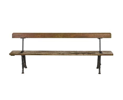 A Victorian cast iron reversible garden bench, with one piece wooden seat and back, 208cm l  Formerly painted, weathered but 