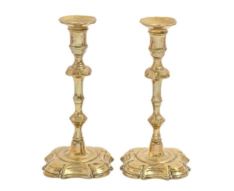 A pair of English brass 'silver' shape candlesticks, c1740, with mushroom knop on moulded foot, 23cm h  Good condition with t