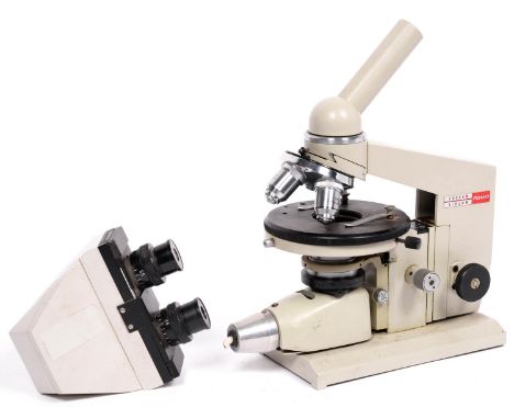 A Soviet Russian compound monocular/binocular microscope 1960's, with two eyepieces and triple objective nose piece, circular