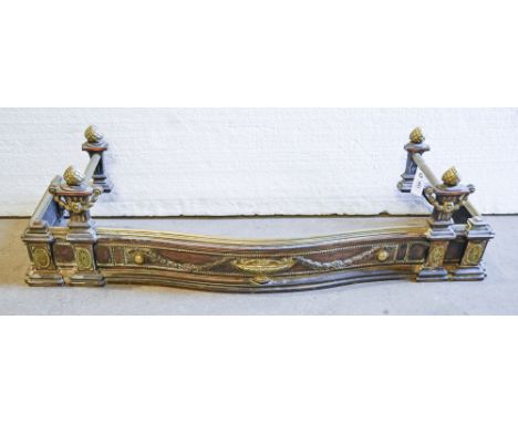 An Edwardian serpentine brass and oxidised art metal fender, with neo classical urn, paterae and festoons, 31cm h; 38 x 125cm